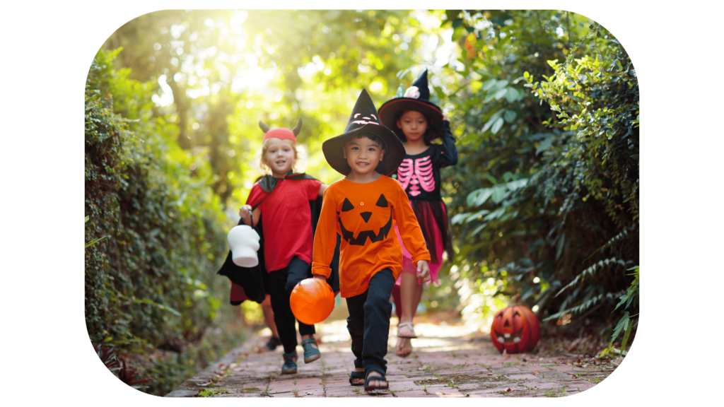 Three children in halloween costumes walking down a path with safety.