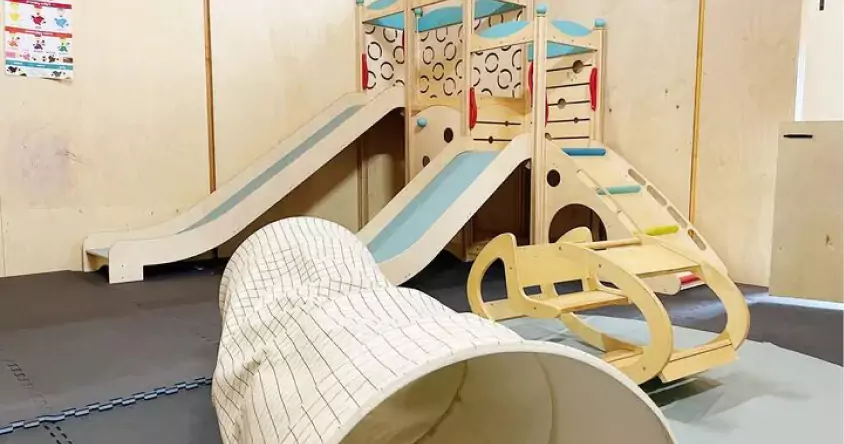 A children's play area with a slide and a wooden slide.